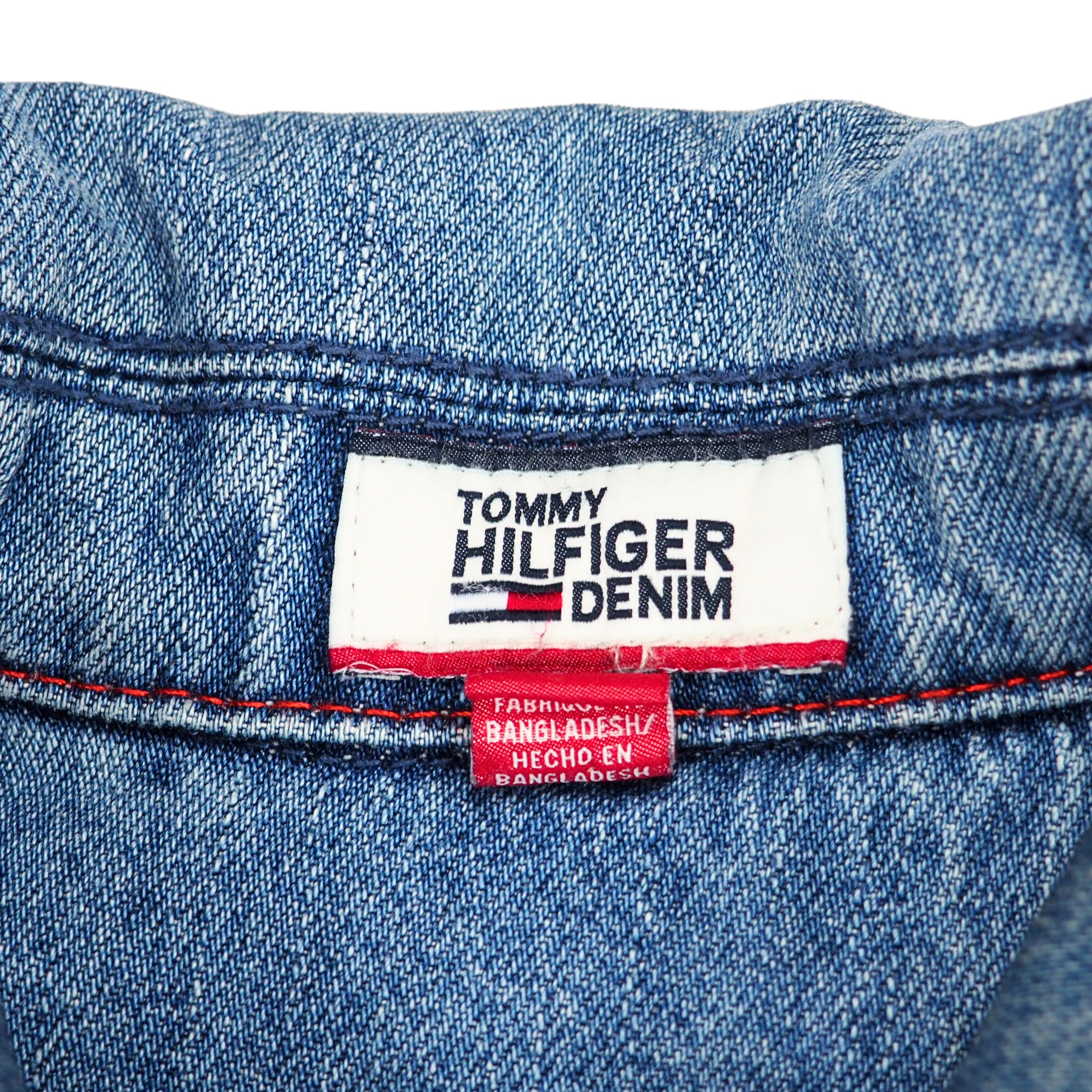 Tommy Hilfiger denim label on a light blue denim background