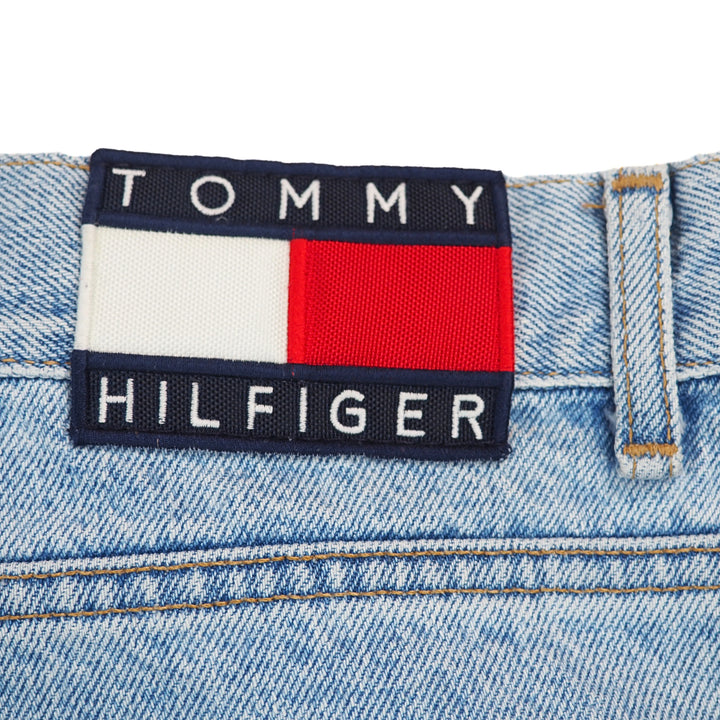 Tommy Hilfiger jacron label on the waistband of a pair of blue denim jeans.