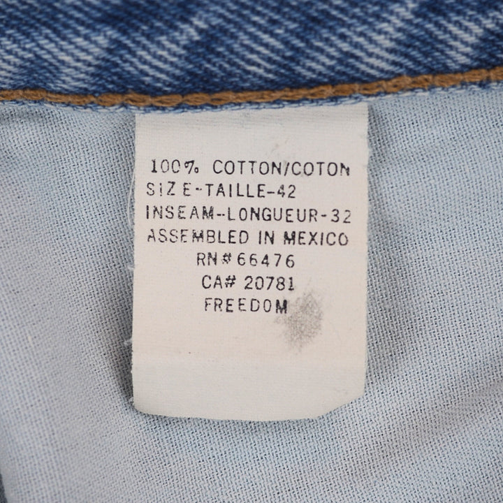White fabric care tag with black text on a denim background