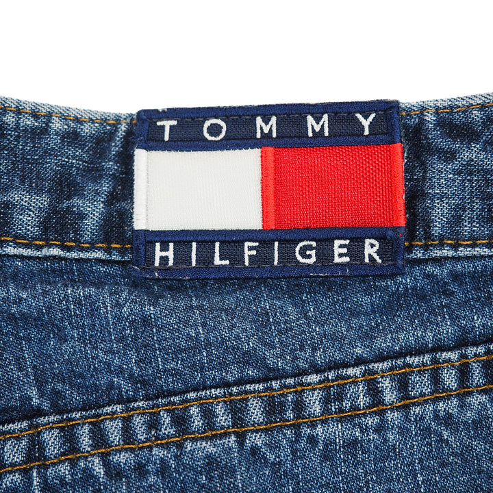 Tommy Hilfiger jacron label on the waistband of a pair of blue denim jeans. 