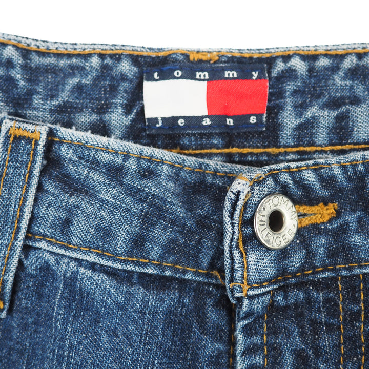 Close-up of Tommy Jeans denim fabric with label and button