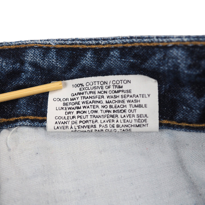 Close-up of a care label on a pair of blue jeans with text on a white background