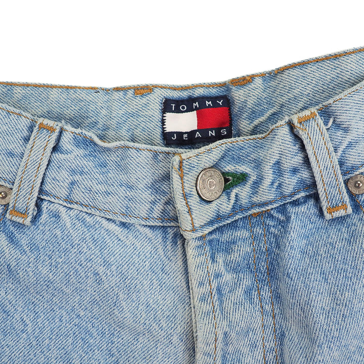 Close-up of a Tommy Jeans label on inside waistband of a pair of light blue denim jeans