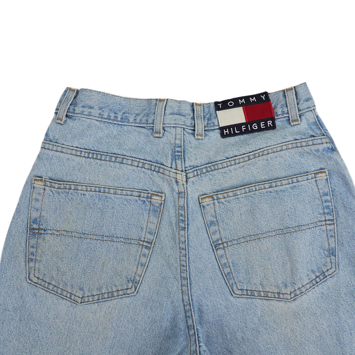 Back view of light blue jeans seat area with Tommy Hilfiger label on a white background