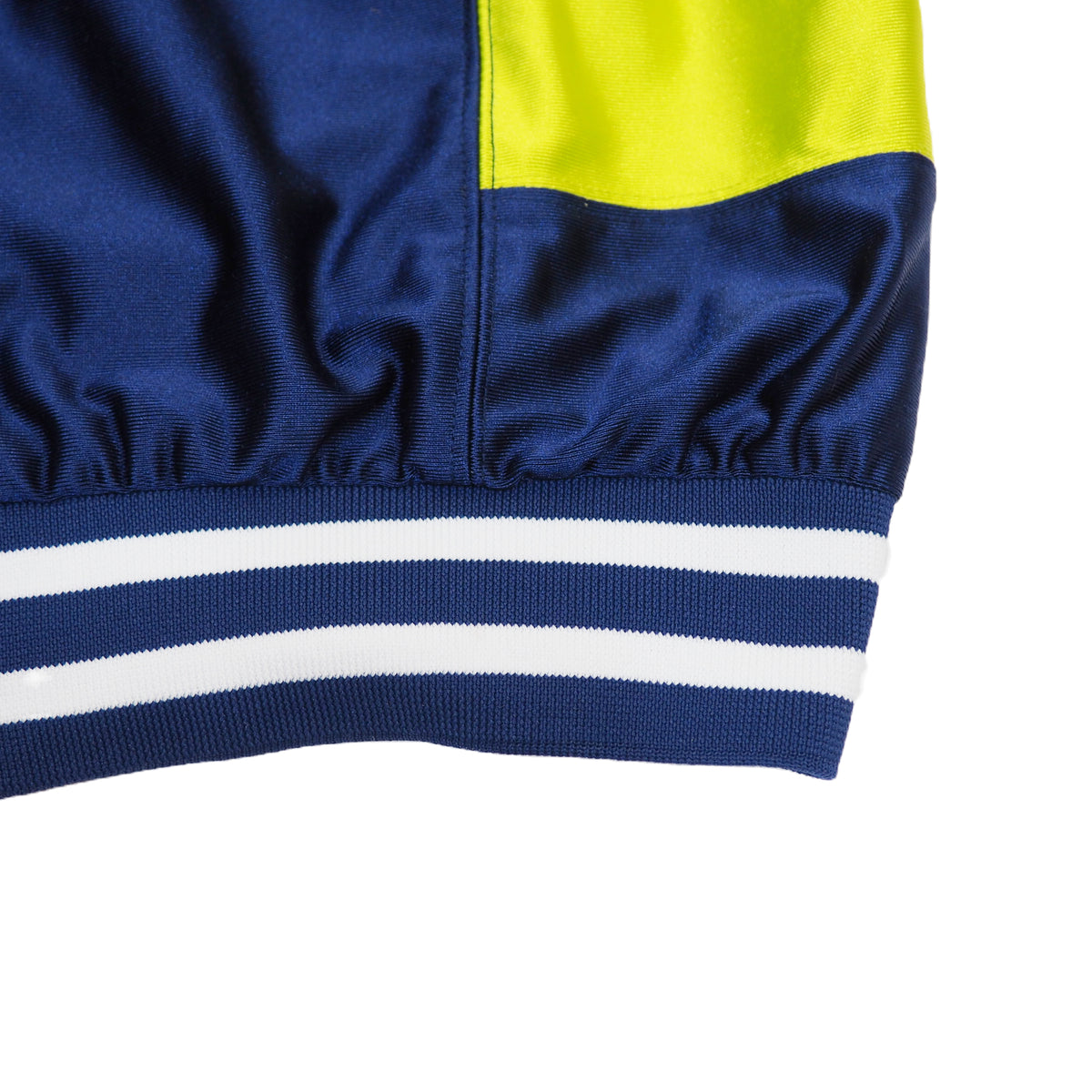 Close-up of a blue and yellow jacket with white stripes on a white background
