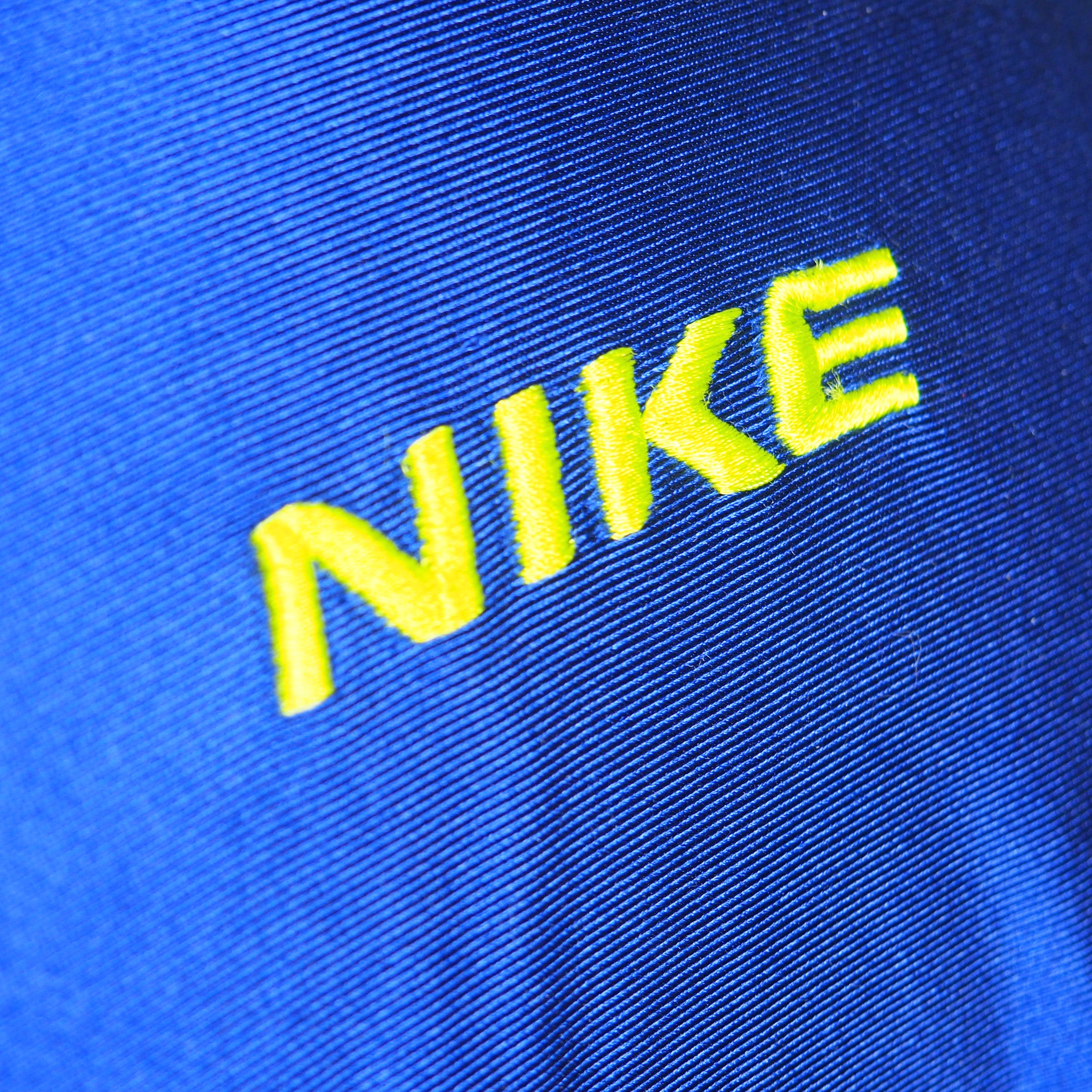 Close-up of Nike logo on a blue fabric background
