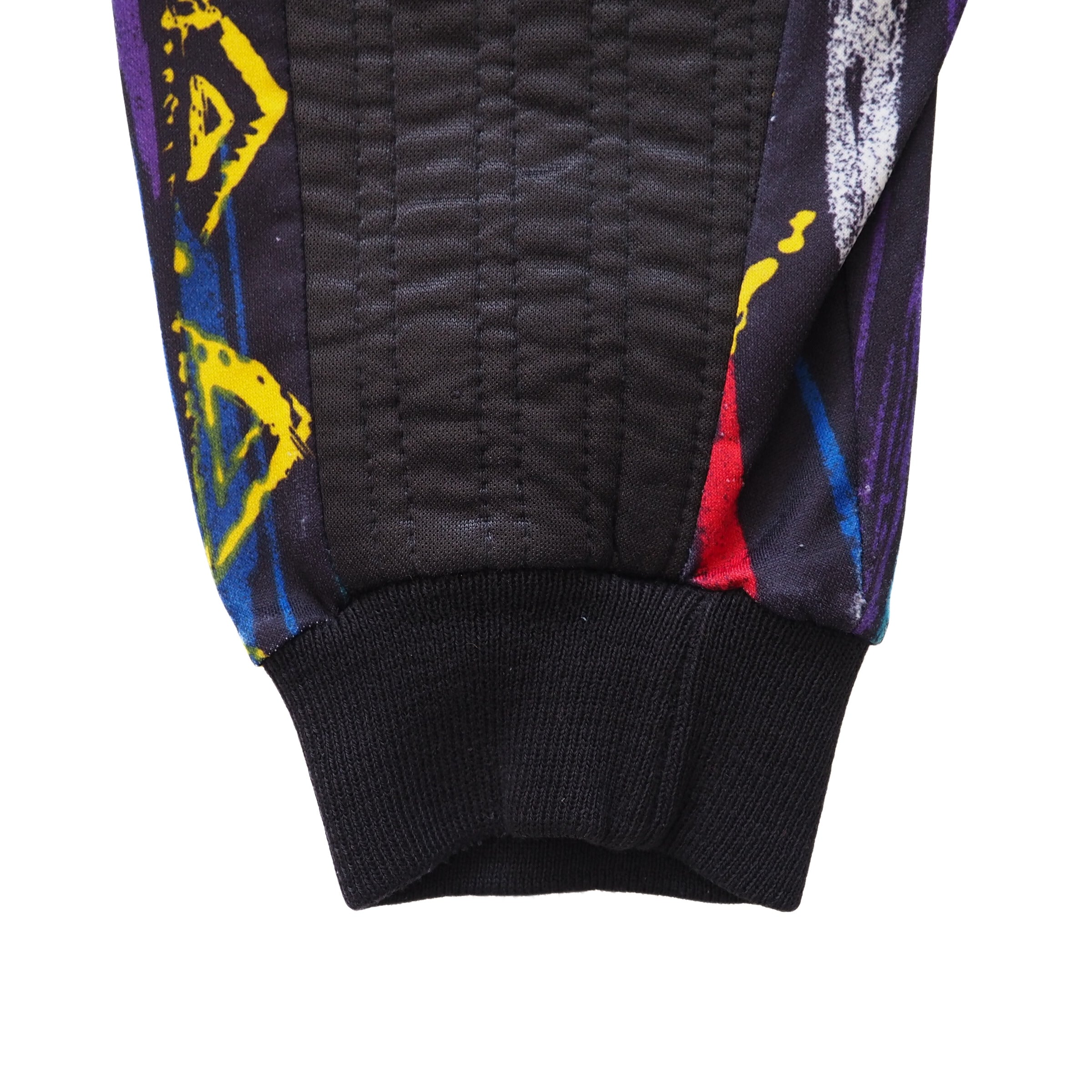 Close-up of sleeve and cuff of a goalkeepers jersey with colorful patterns on a white background