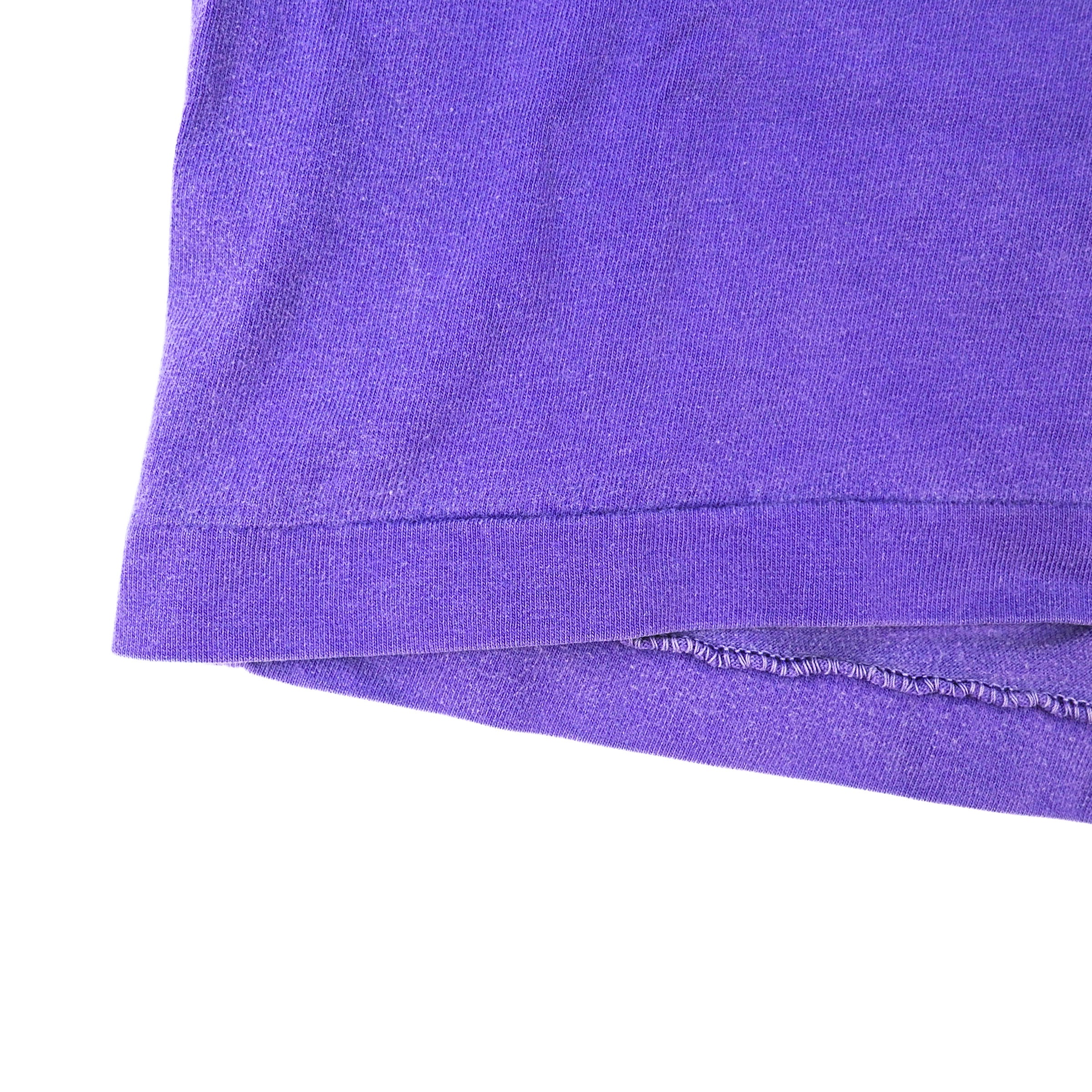 Close-up of a purple fabric edge on a white background