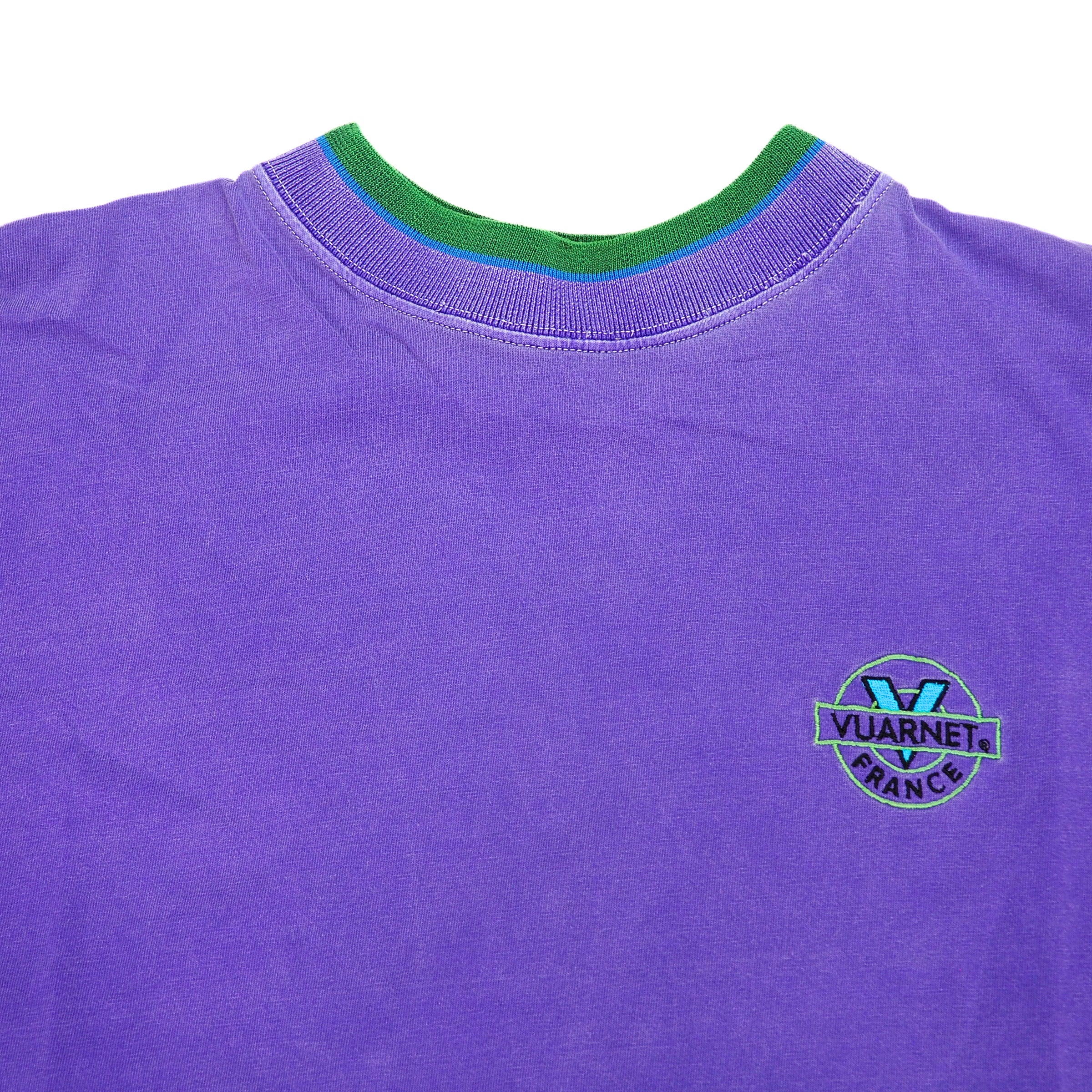 Purple t-shirt with green collar and Vuarnet France logo on a white background