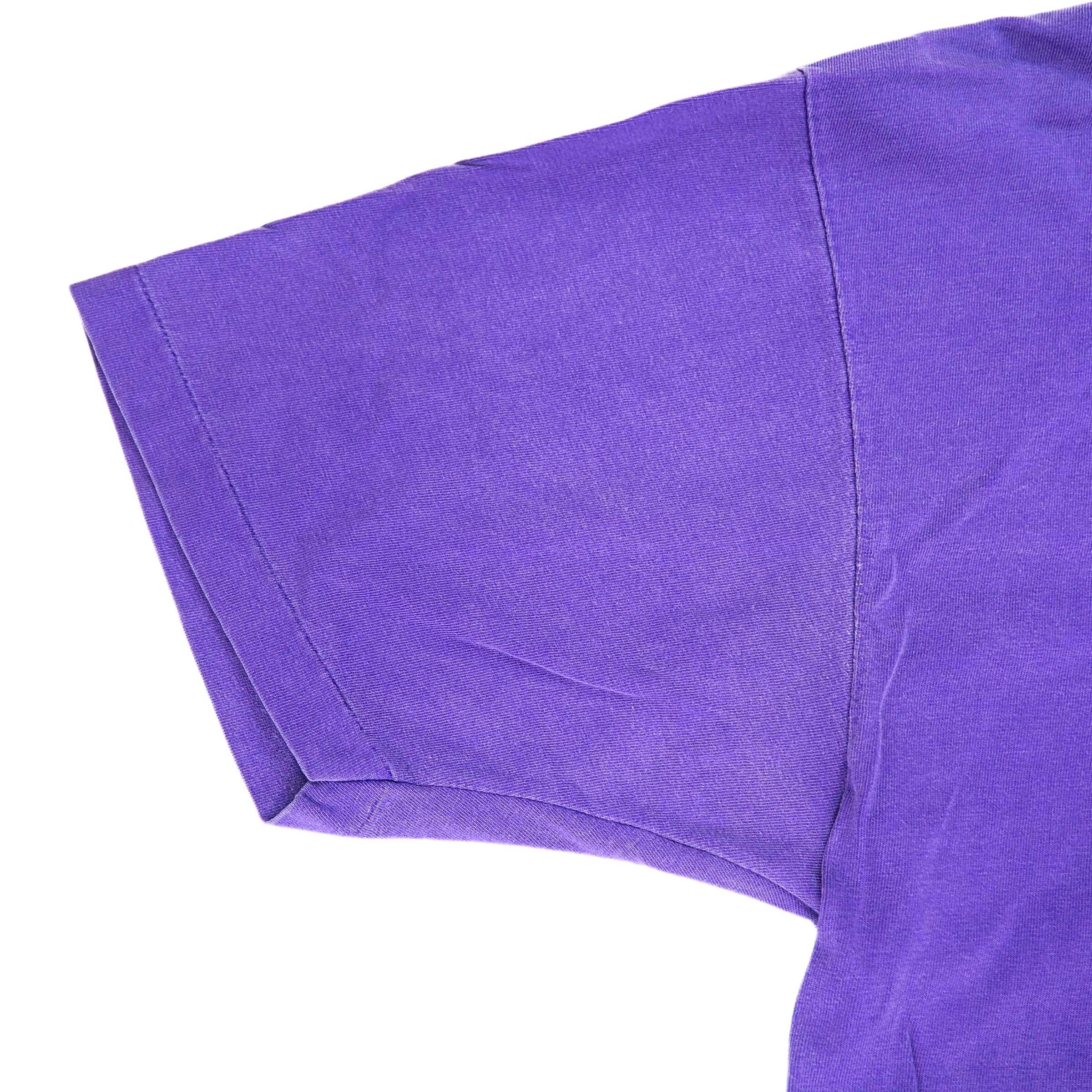 Close-up of a purple t-shirt sleeve on a white background