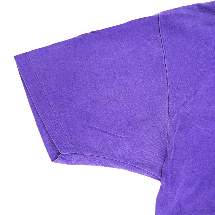 Close-up of a purple t-shirt sleeve on a white background
