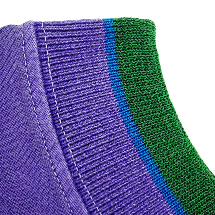 Close-up of a purple and green ribbed t-shirt collar with visible stitching.