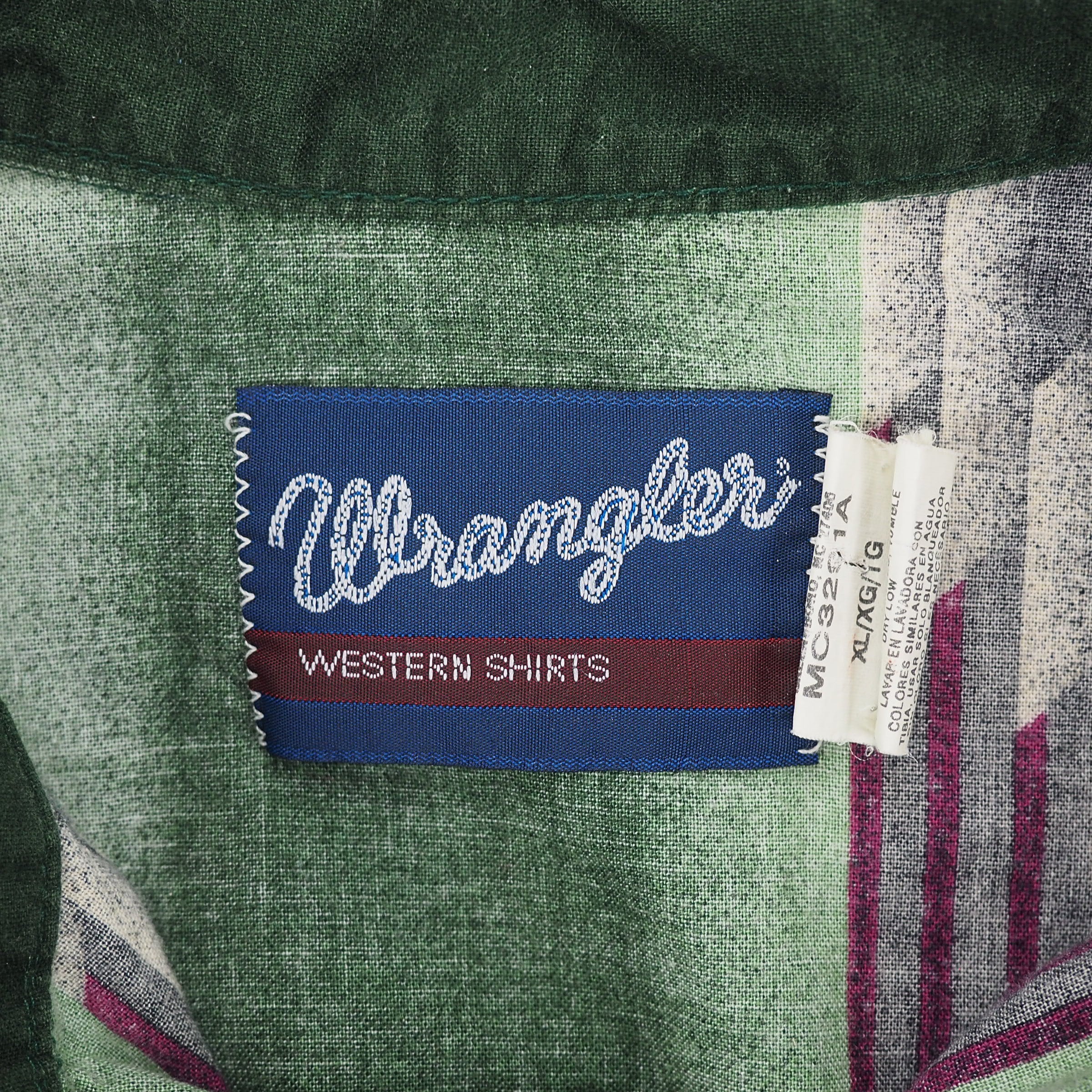 Close up of a Wrangler brand tag on the inside collar of a Western style shirt.