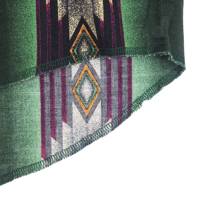 Close up of the hem and stitching details of a south western style shirt with geometric pattern.