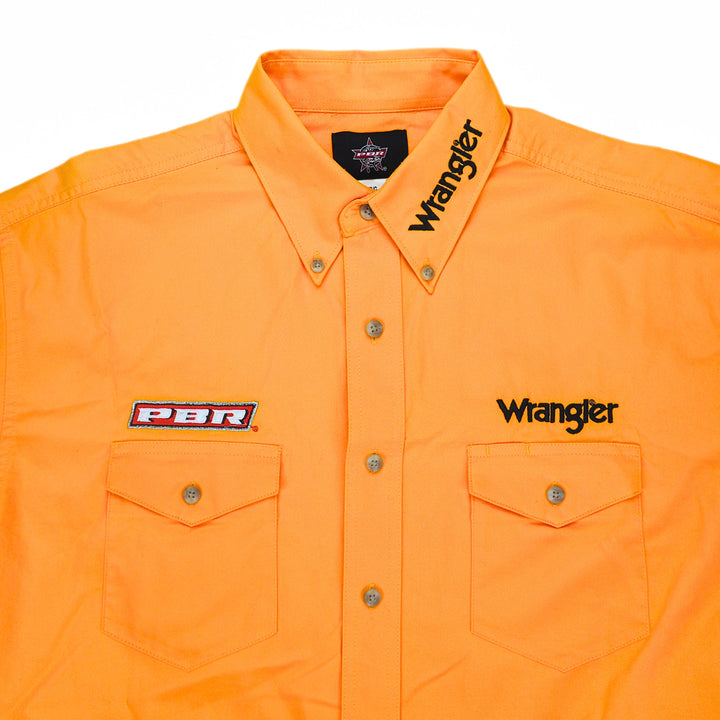 Detail of the chest and collar of a yellow wrangler western shirt with embroidered details