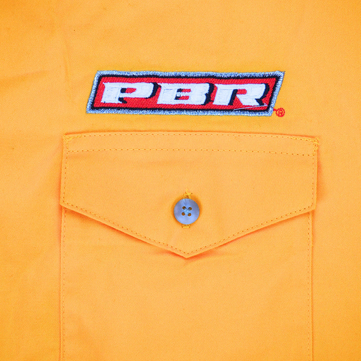 Close up of a dress shirt pocket with flap and button and 'PB' embroidery