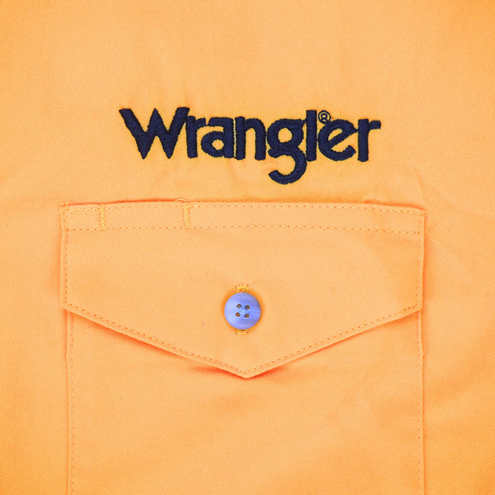 Close up of a dress shirt pocket with 'Wrangler' embroidery