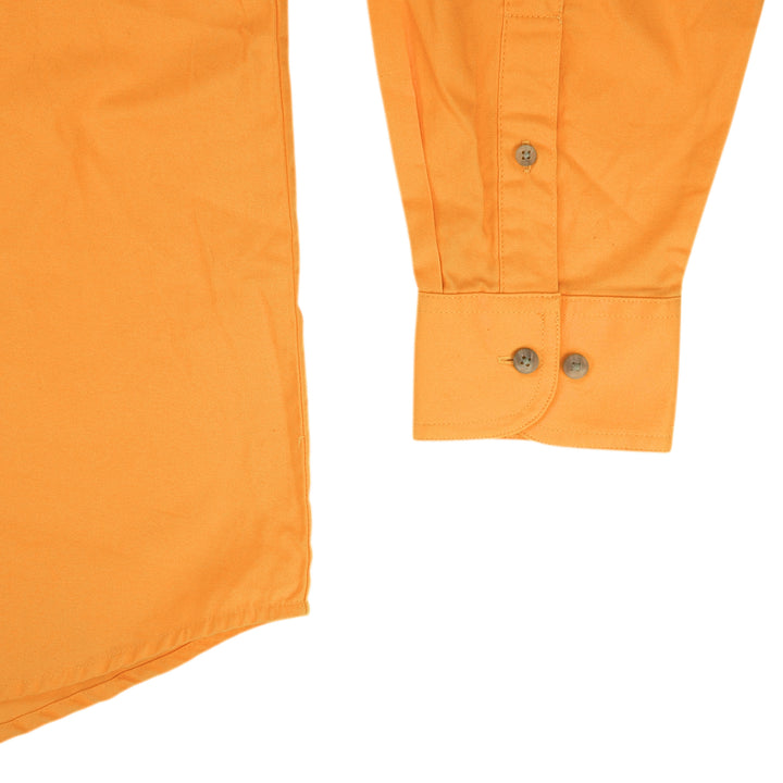 Detail of the sleeve cuff and hem of a yellow dress shirt