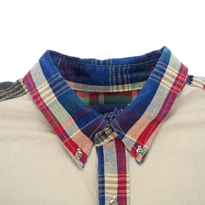 Close up of a button down collared shirt with plaid trim.