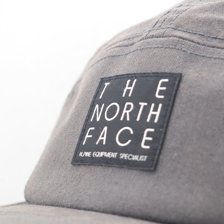 Gray cap with The North Face logo on a white background