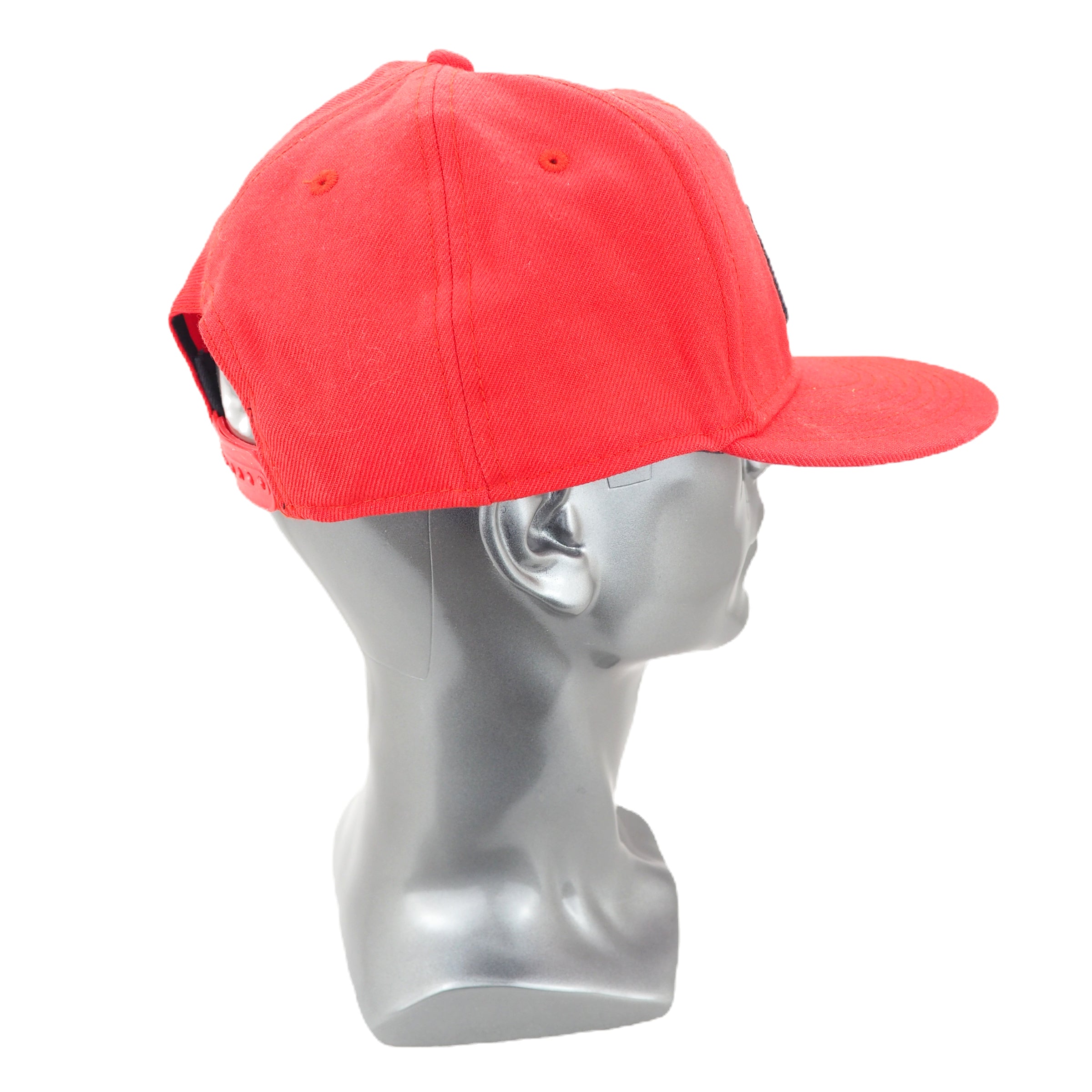 Red cap on a gray mannequin head against a white background