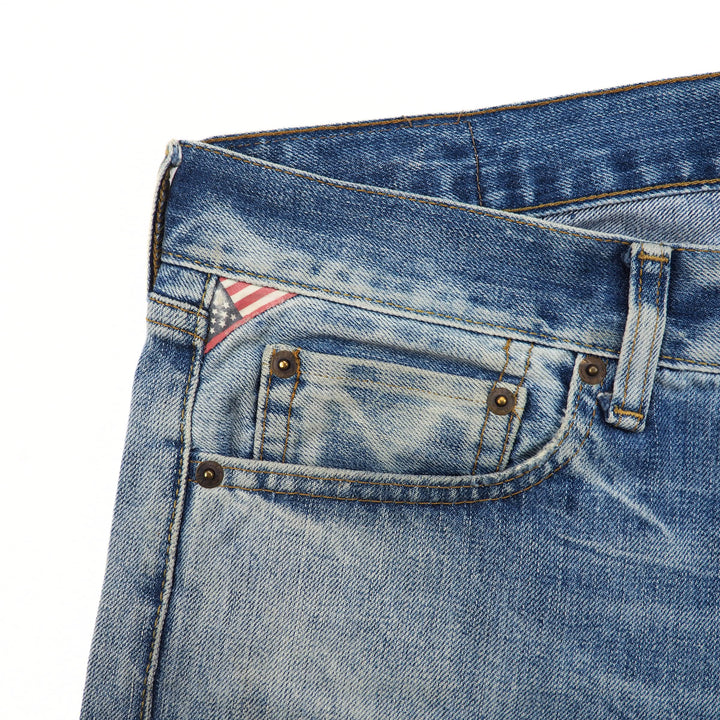 Close-up of a blue denim jean coin pocket with a US flag design on a white background