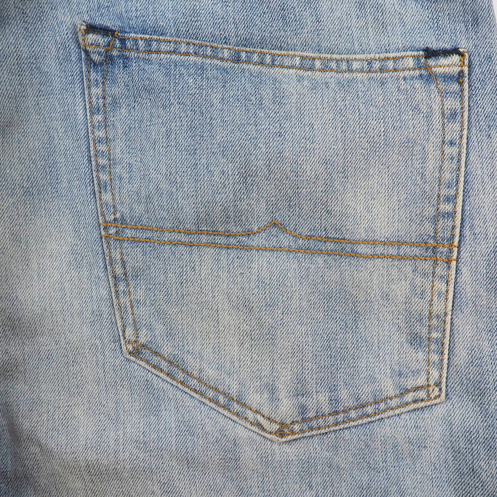 Close-up of a blue denim jean pocket with stitching details