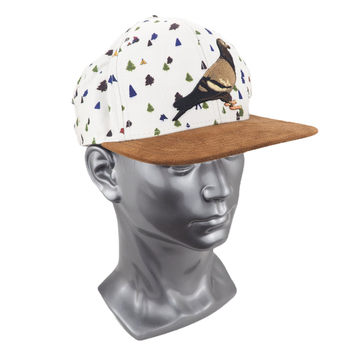 Cap with pidgeon design and suede peak on a mannequin head against a white background