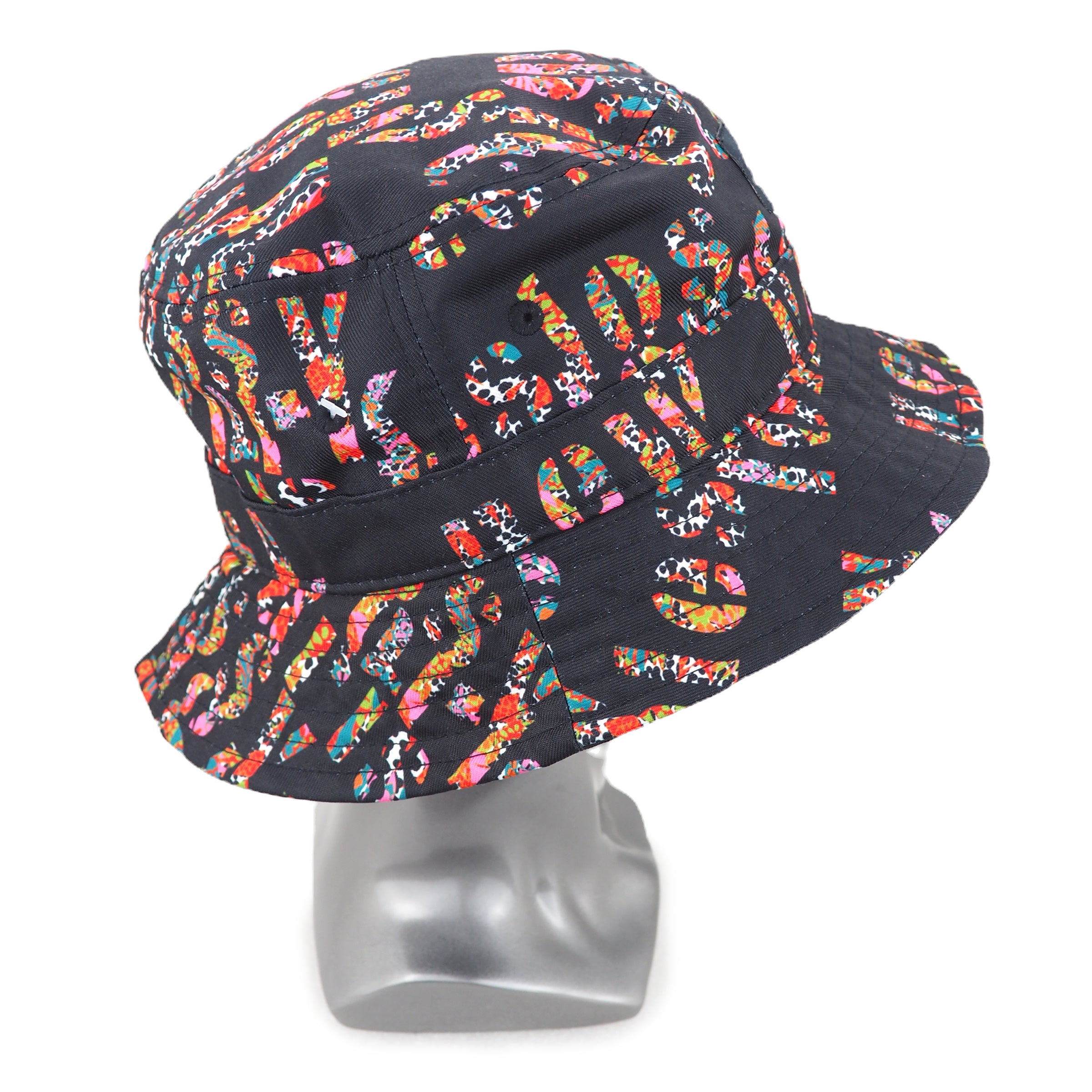 Stussy bucket hat with colorful pattern on a mannequin head against a white background