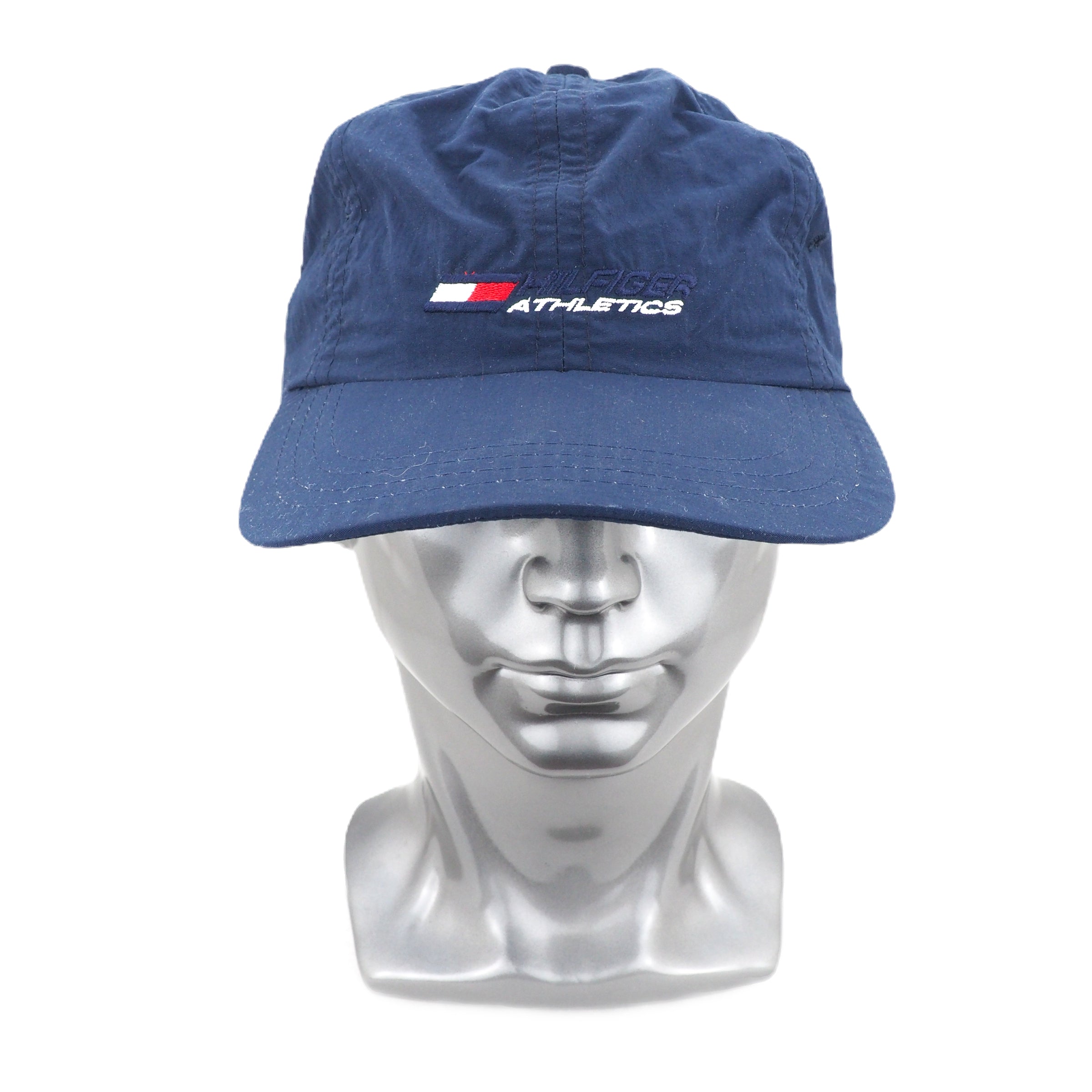 Blue Hilfiger Athletics cap with a logo on a silver mannequin head against a white background