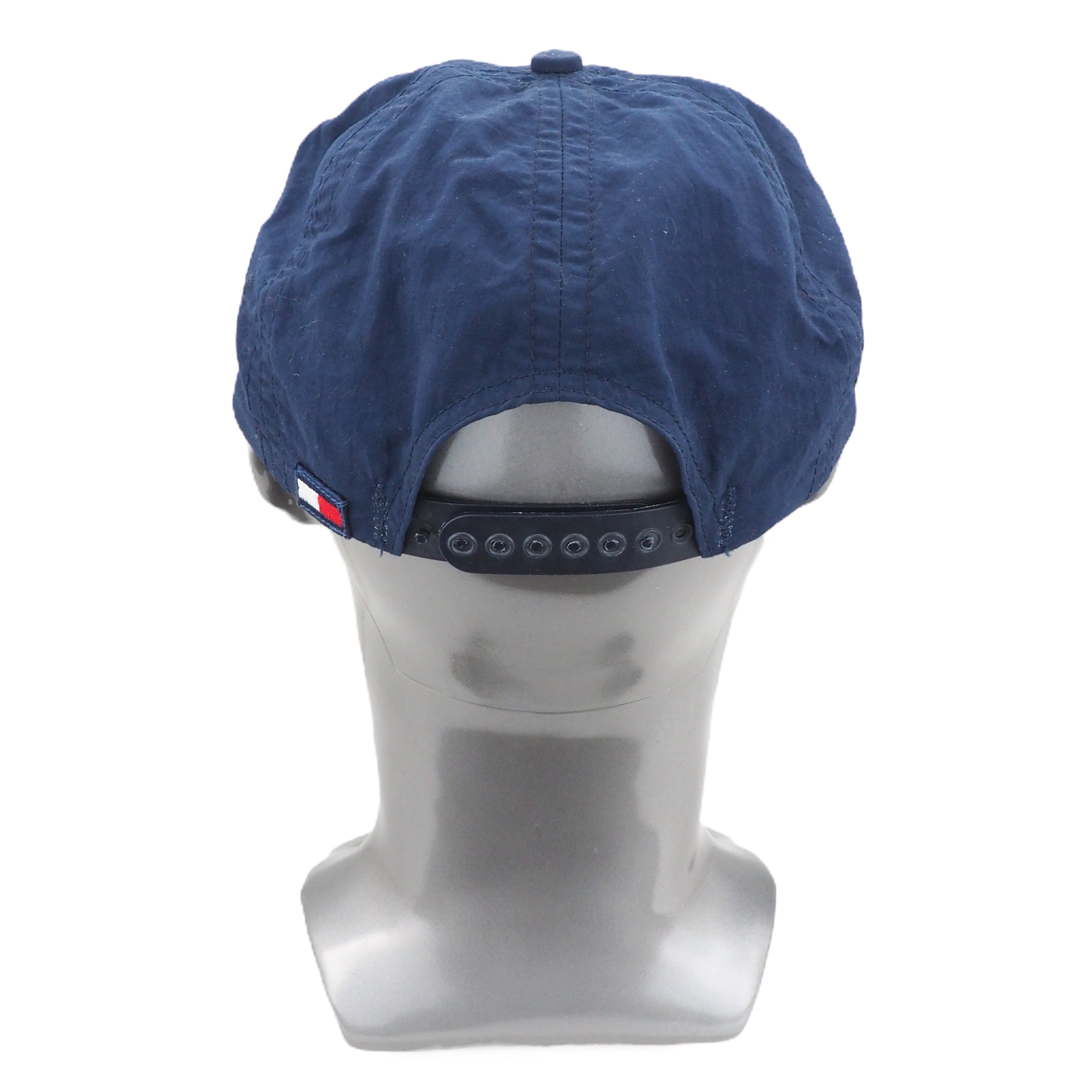 Blue Tommy Hilfiger cap on a mannequin head with a white background