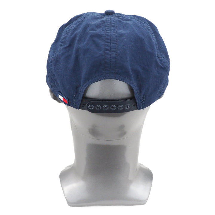 Blue Tommy Hilfiger cap on a mannequin head with a white background