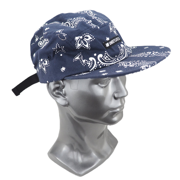 Navy blue bandana-patterned cap on a mannequin head against a white background