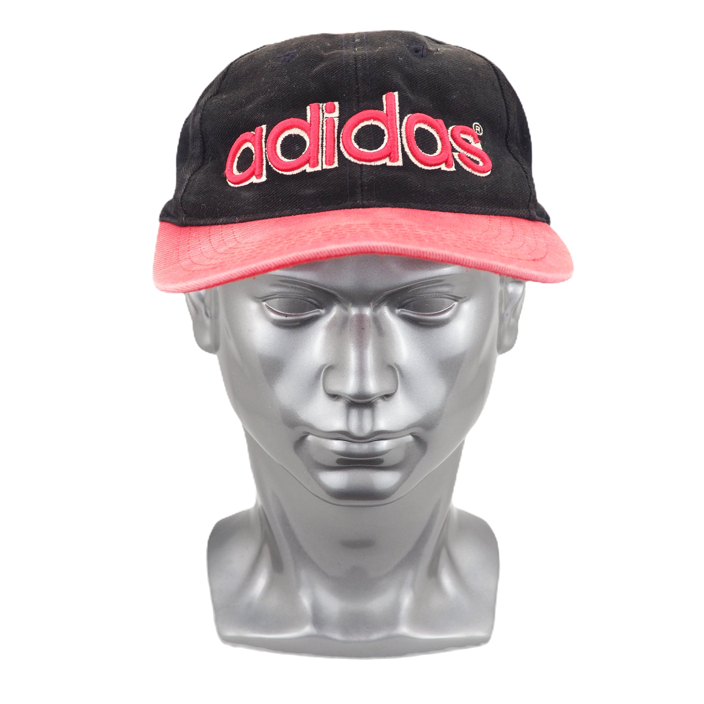 Faded black and red adidas cap on a silver mannequin head against a white background