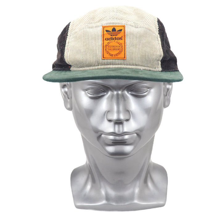 5 panel hat with adidas logo on a silver mannequin head against a white background