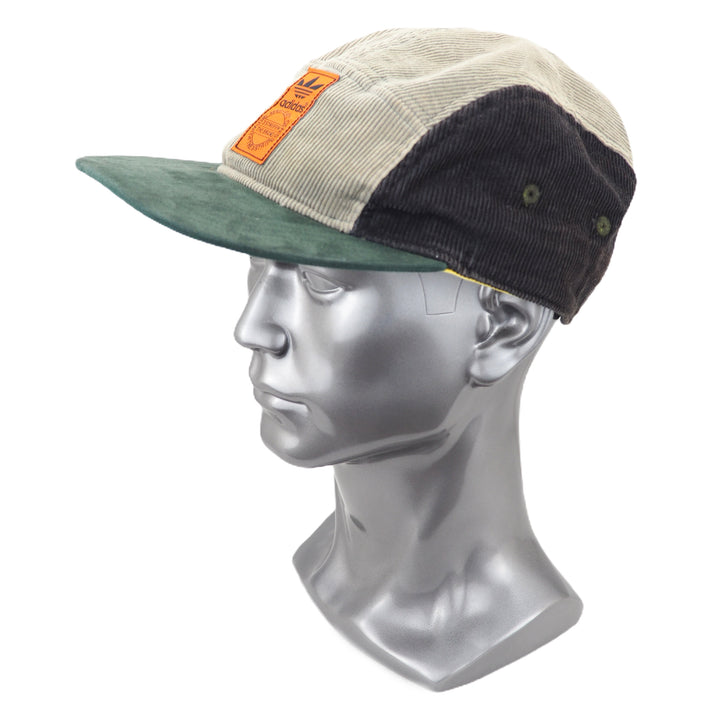 Multicolored corduroy cap on a mannequin head against a white background