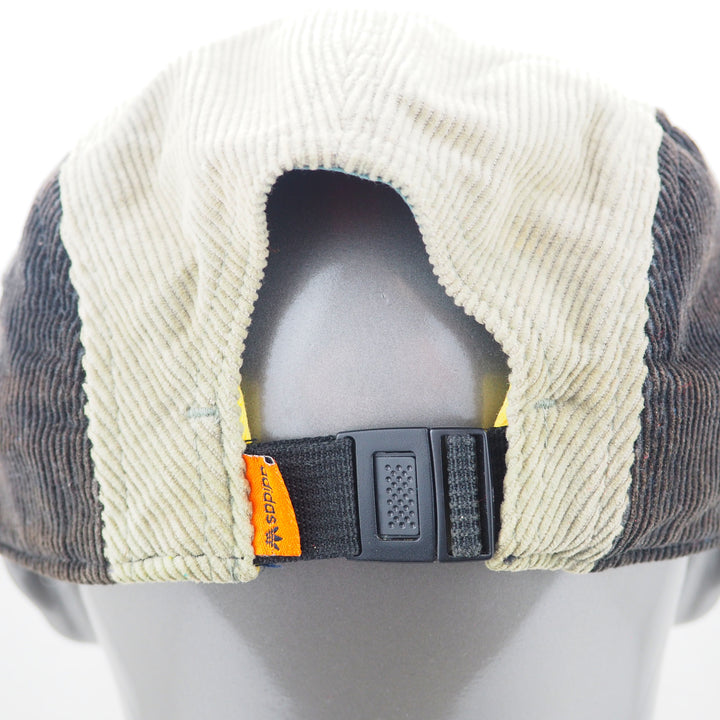 Corduroy cap with a visible adidas brand tag on a mannequin head against a white background