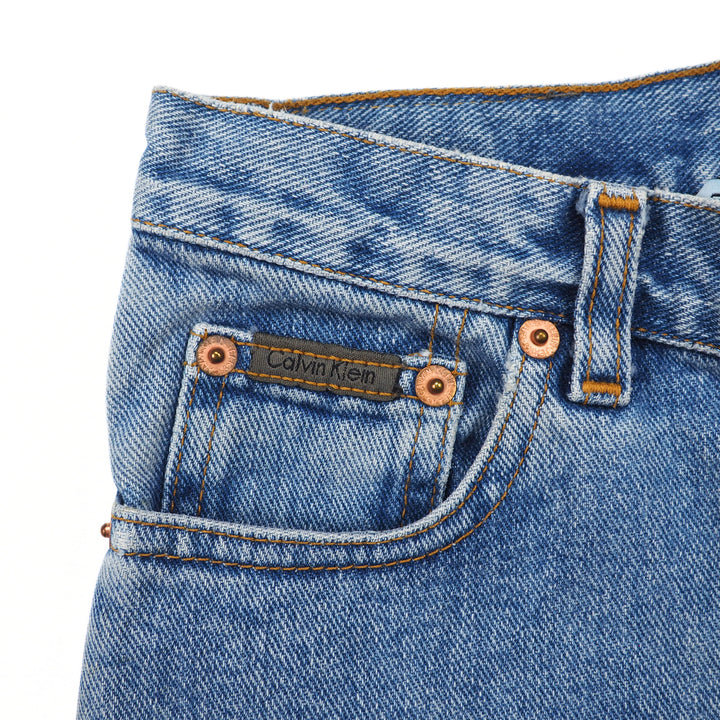 Close-up of a Calvin Klein branded coin pocket on pair of blue denim jeans