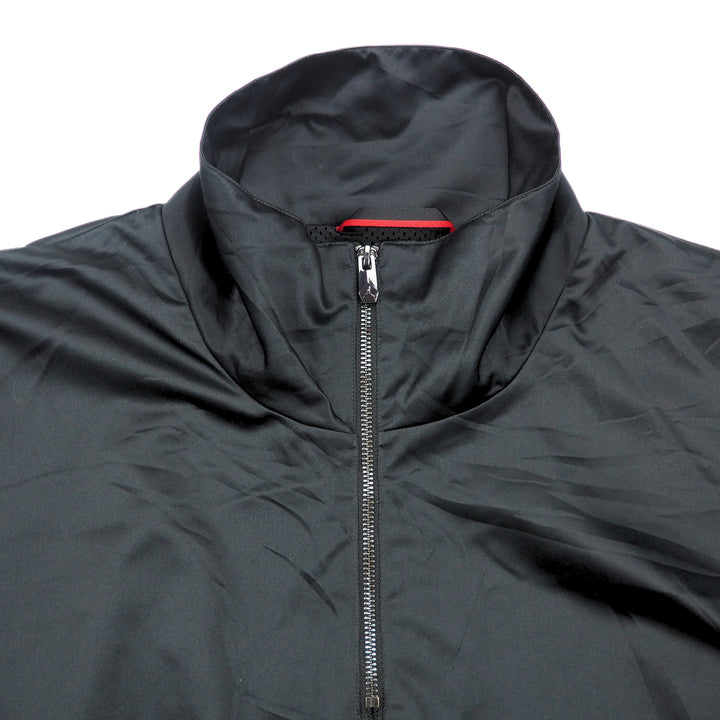 Detail of the front collar of a black jacket with a zipper on a white background