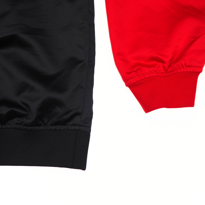 Close-up of black and red jacket body and sleeve on a white background