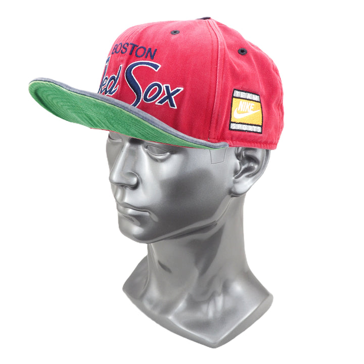 Red baseball cap with 'Boston Red Sox' branding on a mannequin head against a white background