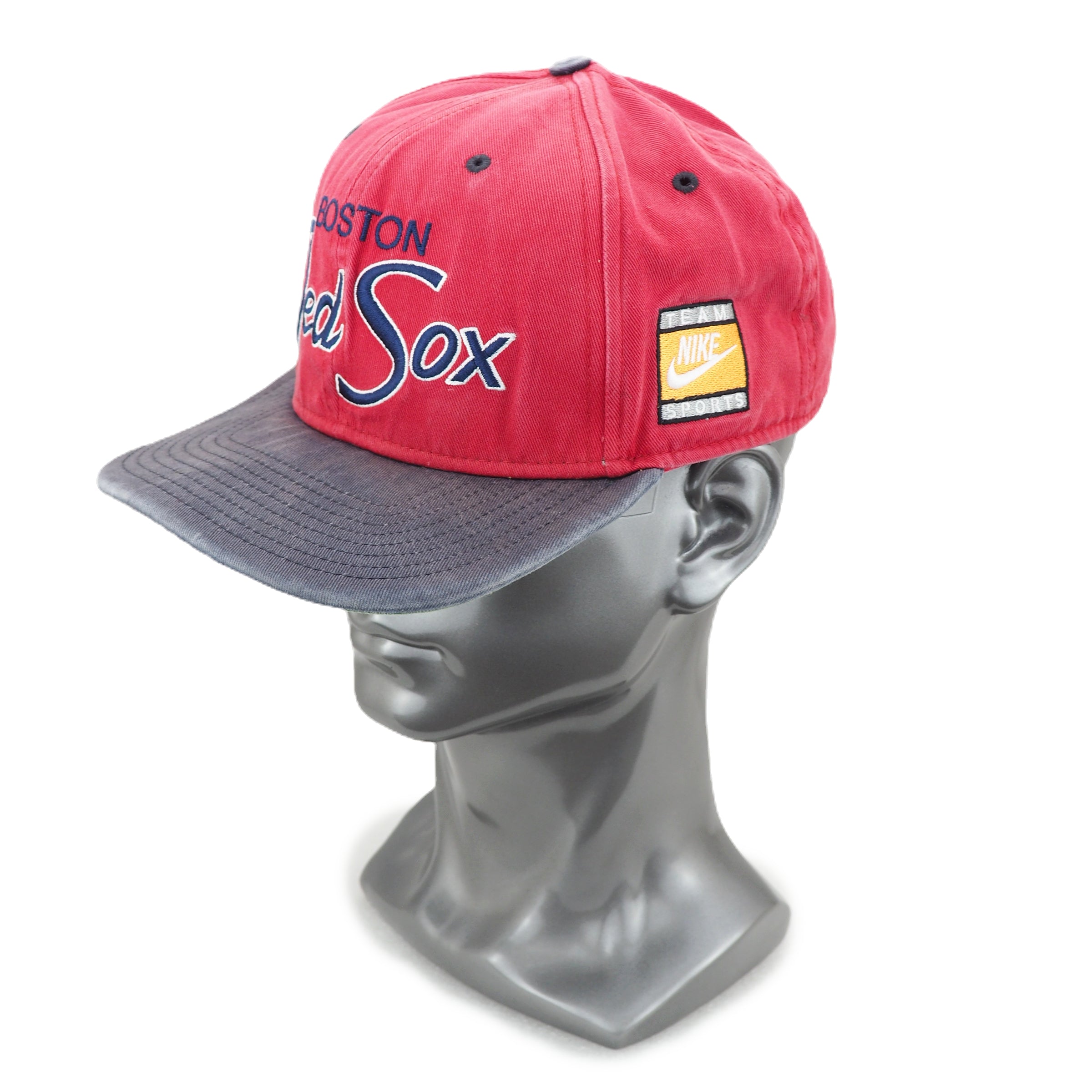 Red baseball cap with 'Boston Red Sox' and Nike logo on a mannequin head against a white background