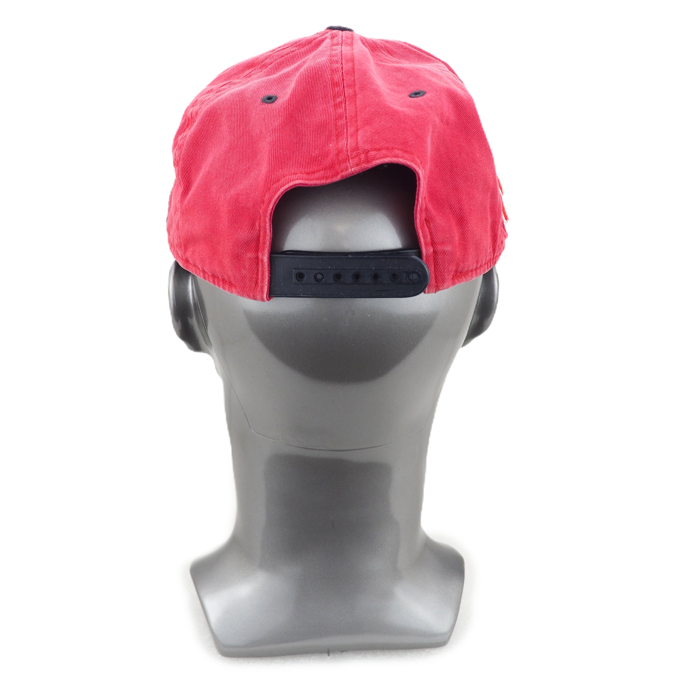 Faded red cap on a gray mannequin head against a white background