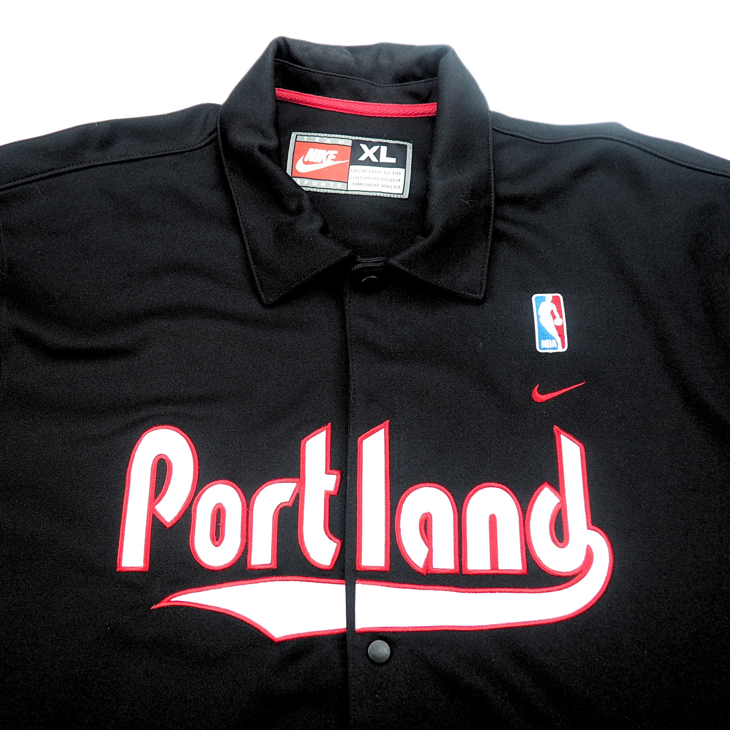 Black jacket with 'Portland' text and Nike Team Sports, Swoosh and NBA logos on a white background