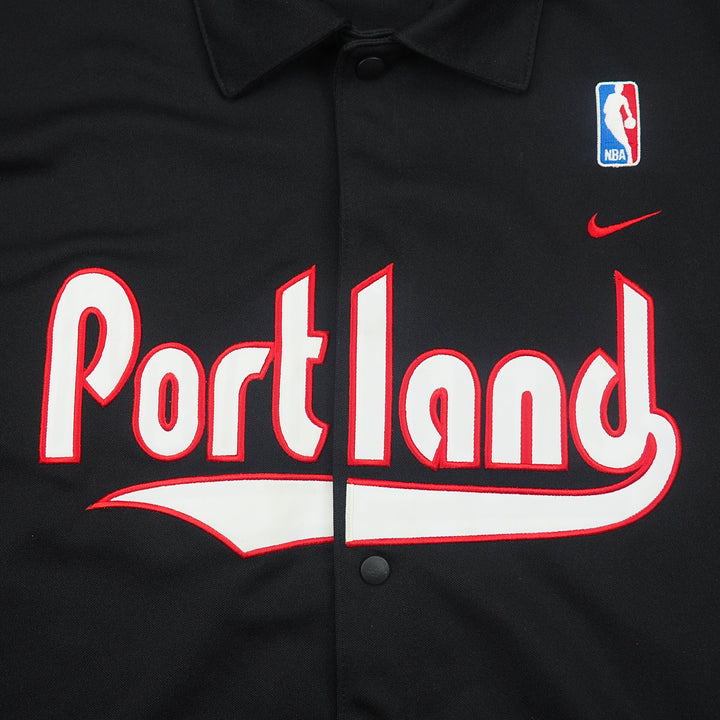 Black Nike basketball warm up jacket with 'Portland' text, Nike swoosh and NBA logo.