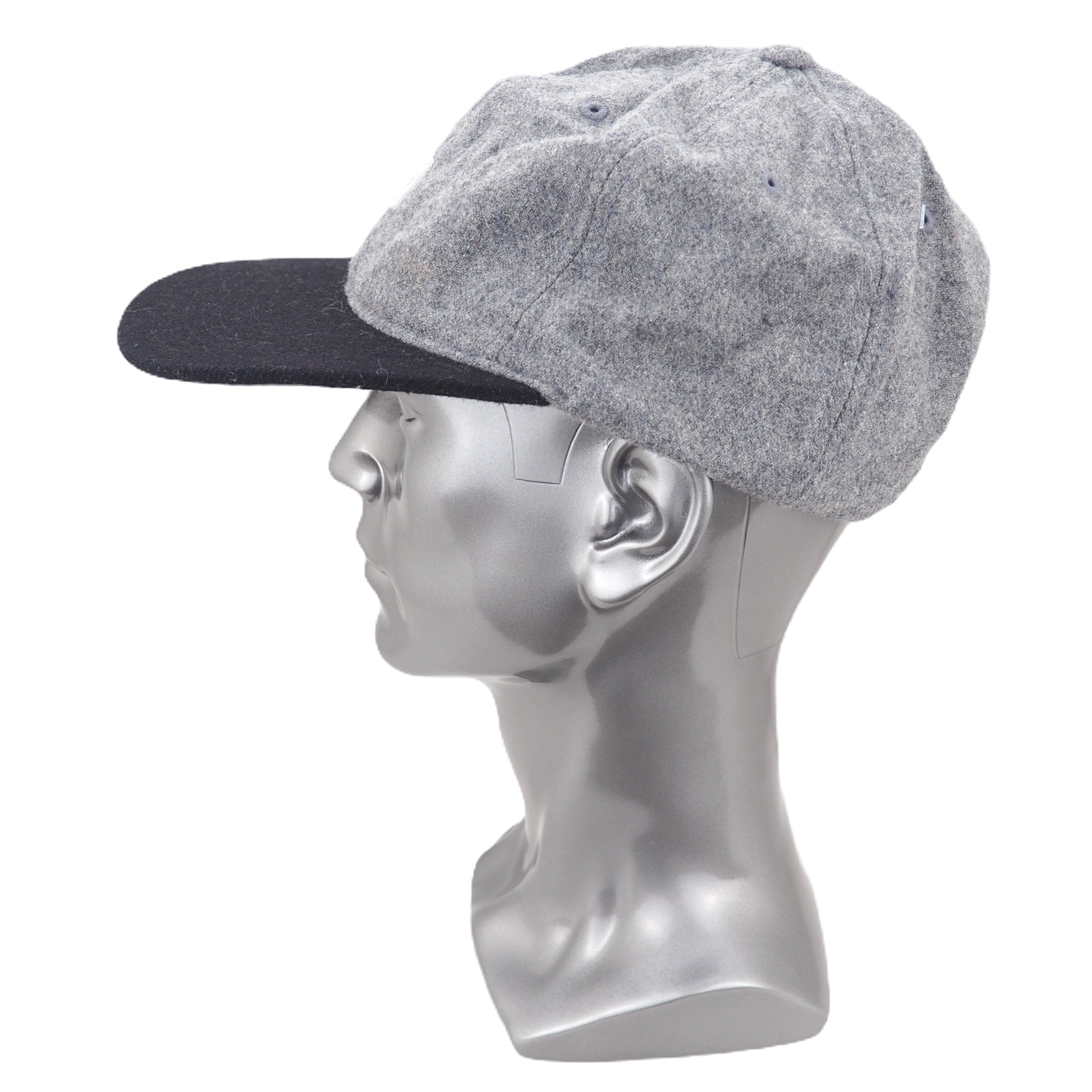 Gray cap on a mannequin head against a white background