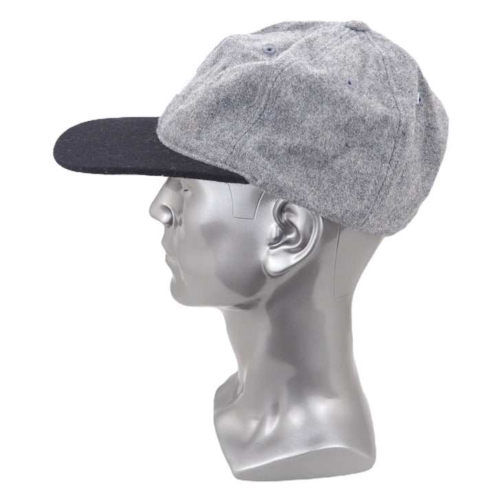 Gray cap on a mannequin head against a white background