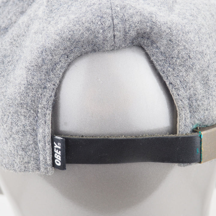 Gray cap with a black adjustable strap on a mannequin head, featuring the Obey logo.